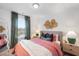 Cozy bedroom featuring a large window and comfortable decor and a textured accent wall at 330 Cottage Hill Way, Knightdale, NC 27604