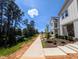 New home featuring modern design, manicured landscaping, and scenic sidewalk access near wooded area and lake at 330 Cottage Hill Way, Knightdale, NC 27604