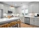 Contemporary kitchen with stainless steel appliances, light gray cabinetry, and center island with seating at 330 Cottage Hill Way, Knightdale, NC 27604