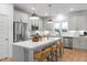 Well-appointed kitchen with stainless appliances, center island with seating, and ample cabinet space at 330 Cottage Hill Way, Knightdale, NC 27604