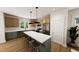 Well-lit kitchen featuring a large island with seating, stainless appliances and wooden flooring at 330 Cottage Hill Way, Knightdale, NC 27604