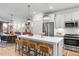 Open-concept kitchen with an island, barstool seating, and stainless steel appliances at 330 Cottage Hill Way, Knightdale, NC 27604