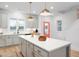 Bright, modern kitchen featuring a large island, pendant lighting and stainless appliances at 330 Cottage Hill Way, Knightdale, NC 27604