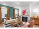Cozy living area with a fireplace, plush seating, and warm wood accents beneath large windows at 330 Cottage Hill Way, Knightdale, NC 27604