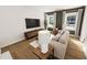 Cozy living room featuring a comfortable sofa and large windows and nice furniture at 330 Cottage Hill Way, Knightdale, NC 27604