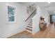 Bright staircase featuring wood treads, white risers, and natural light from a nearby window at 330 Cottage Hill Way, Knightdale, NC 27604