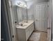 Bathroom featuring double sinks, neutral color palette, and tiled floors at 3510 Rawdon Dr, Durham, NC 27713