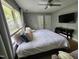 Comfortable bedroom with a large window, neutral walls, and a ceiling fan at 3510 Rawdon Dr, Durham, NC 27713