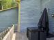 View of the exterior with blue siding, a wooden deck, and outdoor seating area for relaxing at 3510 Rawdon Dr, Durham, NC 27713