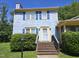 Charming blue two-story home with yellow trim, blue shutters, brick steps, and green landscaping at 3510 Rawdon Dr, Durham, NC 27713