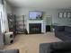 Cozy living room with fireplace, modern shelving, and neutral carpeting at 3510 Rawdon Dr, Durham, NC 27713