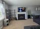 Inviting living room with a fireplace, shelving, and a large flat-screen television at 3510 Rawdon Dr, Durham, NC 27713