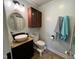 Charming bathroom featuring a vintage-style vanity with a vessel sink, a medicine cabinet, and updated fixtures at 358 Pool Rock Shores Ln, Henderson, NC 27537