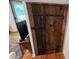 Solid wood door with rustic iron hardware, adding to the room's character at 358 Pool Rock Shores Ln, Henderson, NC 27537
