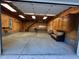 Large garage interior features a staircase leading to a second story space and a wood-paneled interior at 358 Pool Rock Shores Ln, Henderson, NC 27537