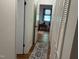 Hallway with hardwood floors, leading to a room with natural light and closet space at 358 Pool Rock Shores Ln, Henderson, NC 27537