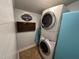 Efficient laundry room with stacked washer and dryer units, optimizing space at 358 Pool Rock Shores Ln, Henderson, NC 27537