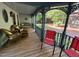 Charming covered porch with swing and seating at 358 Pool Rock Shores Ln, Henderson, NC 27537