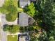 Aerial view showcases the home's roof, driveway, and surrounding lush green trees at 3620 Arrowwood Dr, Raleigh, NC 27604