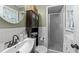 Compact bathroom featuring a vanity with updated faucet and a glass-enclosed shower at 3620 Arrowwood Dr, Raleigh, NC 27604
