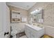 Charming bathroom featuring decorative wallpaper, a white vanity, and classic fixtures at 3620 Arrowwood Dr, Raleigh, NC 27604