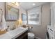 Bright bathroom with a modern vanity, large mirror, and natural light from the window at 3620 Arrowwood Dr, Raleigh, NC 27604