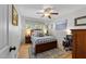 Bedroom features a bed, ceiling fan, wood floors, and a closet at 3620 Arrowwood Dr, Raleigh, NC 27604