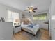 Bedroom featuring natural light, wood flooring, ceiling fan and two dressers at 3620 Arrowwood Dr, Raleigh, NC 27604