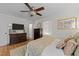 Bedroom features wood flooring, ceiling fan and a dresser at 3620 Arrowwood Dr, Raleigh, NC 27604