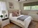 Bright bedroom with plush bedding, complemented by white furniture and an area rug at 3620 Arrowwood Dr, Raleigh, NC 27604