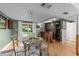 Well lit dining area featuring a full bar and a sliding glass door to the exterior at 3620 Arrowwood Dr, Raleigh, NC 27604