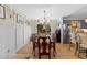 Bright dining room featuring a hardwood floor, floral wallpaper, and direct access to kitchen at 3620 Arrowwood Dr, Raleigh, NC 27604