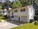 Two-story home with attached garage, flower boxes, a well-manicured lawn, and walkway at 3620 Arrowwood Dr, Raleigh, NC 27604