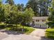 Aerial view of a two-story home with a well-manicured lawn, driveway, and mature trees at 3620 Arrowwood Dr, Raleigh, NC 27604