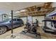 Garage featuring fitness equipment, storage, and parking space for a vehicle at 3620 Arrowwood Dr, Raleigh, NC 27604