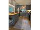 Modern kitchen featuring gray cabinets, stainless steel appliances, an island and a stylish rug at 3620 Arrowwood Dr, Raleigh, NC 27604