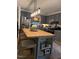 Stylish kitchen featuring gray cabinets, stainless steel appliances, a butcher block island and pendant lighting at 3620 Arrowwood Dr, Raleigh, NC 27604