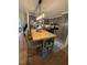 Bright kitchen featuring gray cabinets, stainless steel appliances, a butcher block island and a light fixture at 3620 Arrowwood Dr, Raleigh, NC 27604