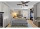 Bright bedroom featuring a comfortable bed, ceiling fan, and closet storage at 3620 Arrowwood Dr, Raleigh, NC 27604