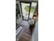 Staircase featuring sisal carpet, brick flooring, and wooden accents with a small cabinet at 3620 Arrowwood Dr, Raleigh, NC 27604