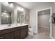 Modern bathroom featuring a double vanity, ample storage, and an adjacent walk-in closet, offering convenience and luxury at 408 Grand Silo Rd, Garner, NC 27603