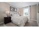 Bedroom with a neutral color scheme, carpeted floors, large window, and stylish décor at 408 Grand Silo Rd, Garner, NC 27603