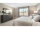Tastefully designed bedroom featuring a dresser, plush bedding, carpet and bright window at 408 Grand Silo Rd, Garner, NC 27603