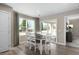 Inviting dining area with sliding glass doors leading to an outdoor space, complemented by stylish decor and ample lighting at 408 Grand Silo Rd, Garner, NC 27603