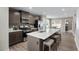 Open kitchen with stainless appliances, seating island and a view of the eat-in area at 408 Grand Silo Rd, Garner, NC 27603