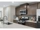 Bright kitchen with stainless steel appliances, quartz countertops, and stylish backsplash at 408 Grand Silo Rd, Garner, NC 27603