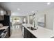 Open kitchen with stainless steel appliances, large island, and dining area beyond at 408 Grand Silo Rd, Garner, NC 27603