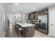 Open kitchen with stainless steel appliances, quartz island with seating and open floorplan at 408 Grand Silo Rd, Garner, NC 27603