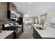 Open kitchen with stainless steel appliances and large island overlooking the dining area at 408 Grand Silo Rd, Garner, NC 27603