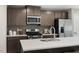 Modern kitchen features stainless steel appliances, gray cabinets, and quartz countertops at 408 Grand Silo Rd, Garner, NC 27603